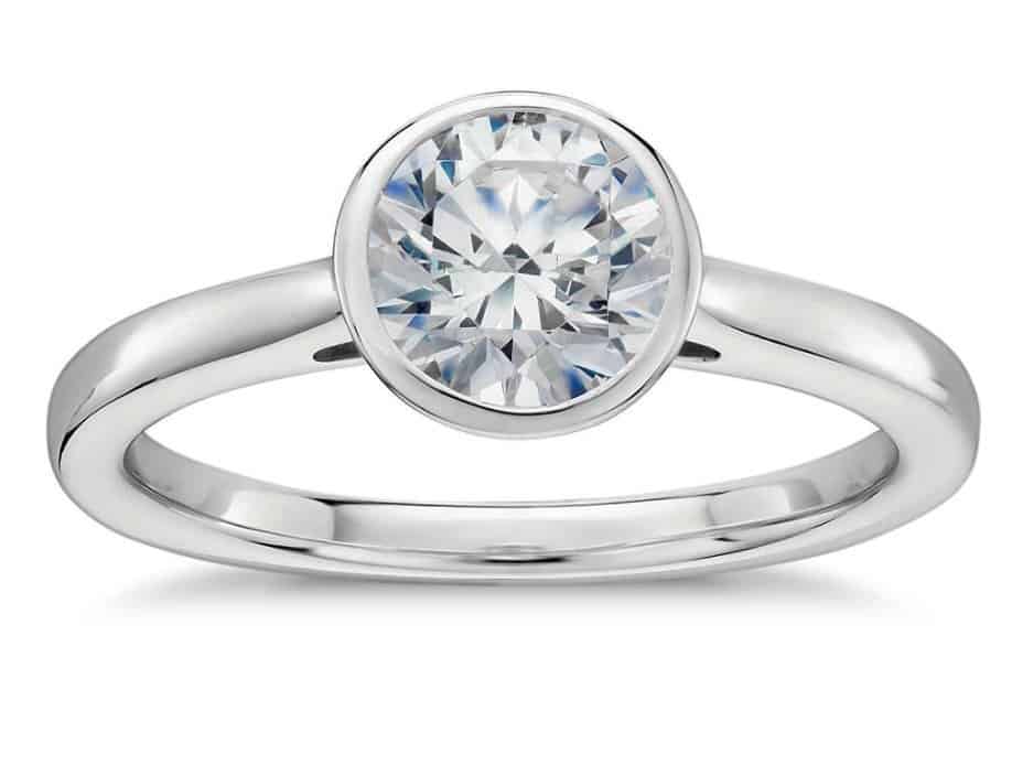 bezel set solitaire engagement ring in platinum with round